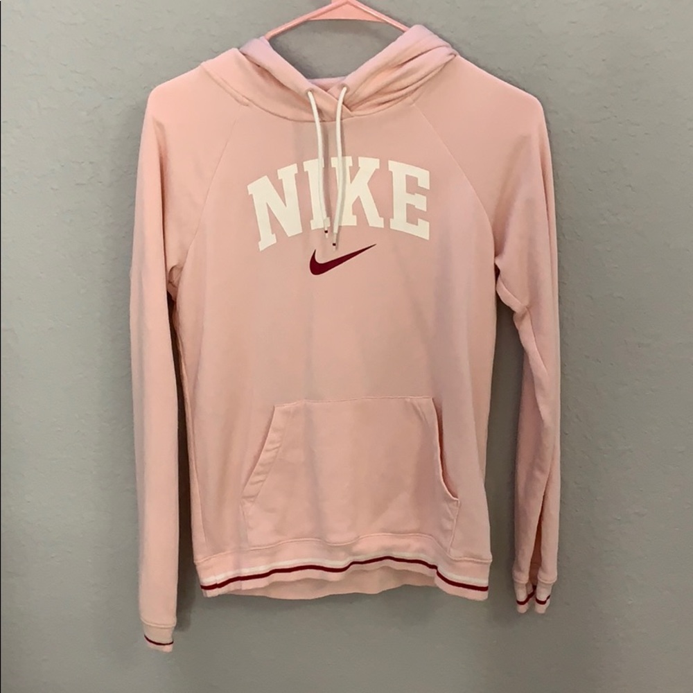 A coralish  pink Nike hoodie